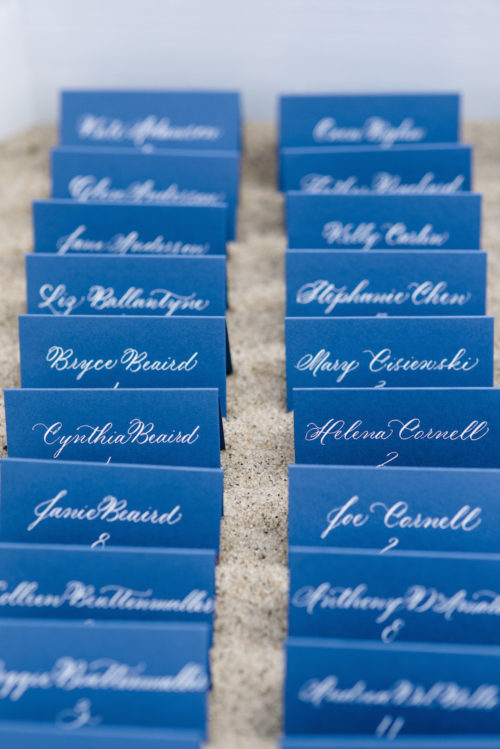 design darling wedding navy escort cards with white calligraphy