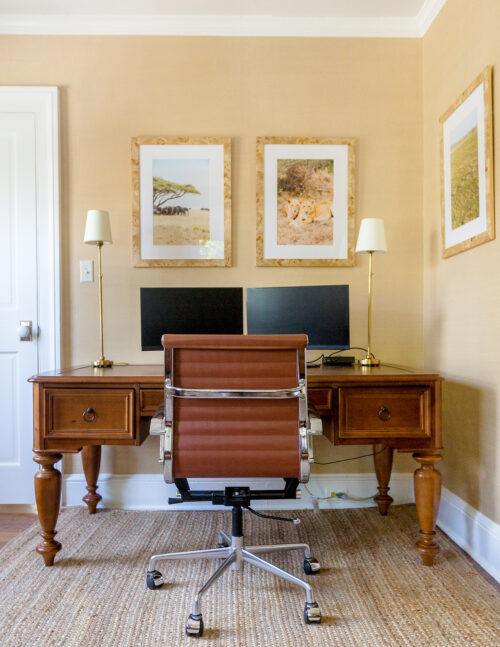 masculine home office wood desk leather desk chair brass lamps burl wood frames
