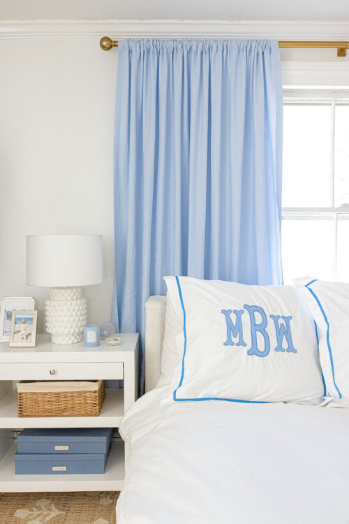 light blue linen curtains behind bed with southern linen monogrammed euro shams